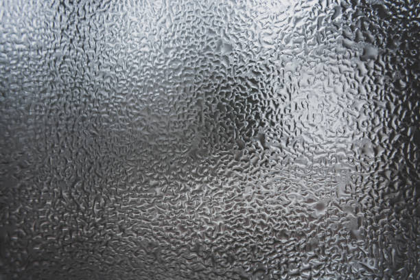istock Abstract pattern of melt water on the window glass. 1389308403
