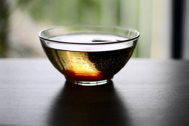 bowl of tea in the dark. the bowl is placed on a table (or desk)
