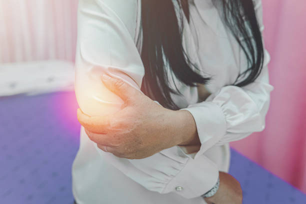 istock older woman suffering from elbow pain, 1389308613