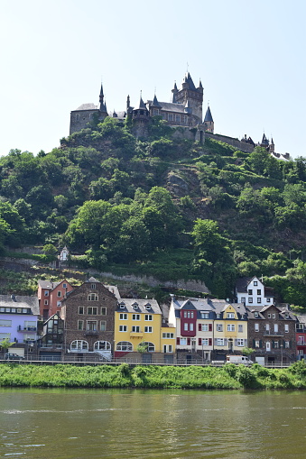 Cochem, Germany - 06/17/2021: color Mosel road houses with Reichsburg above