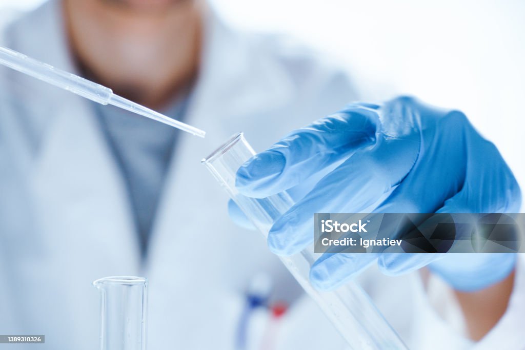 Microbiological research with a test tube and micropipette in close -up Microbiological research with a test tube and micropipette in hands of a laboratory worker in close-up Laboratory Stock Photo