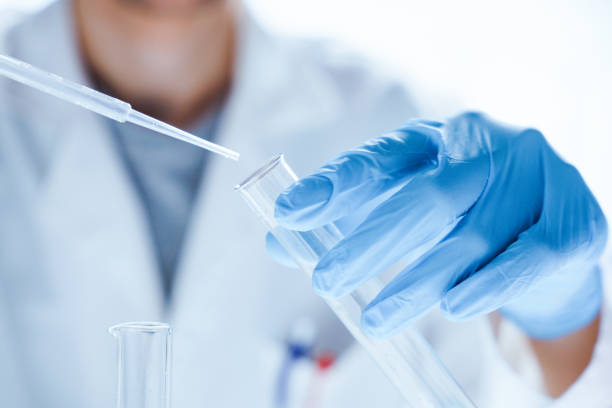 microbiological research with a test tube and micropipette in close -up - medical test imagens e fotografias de stock