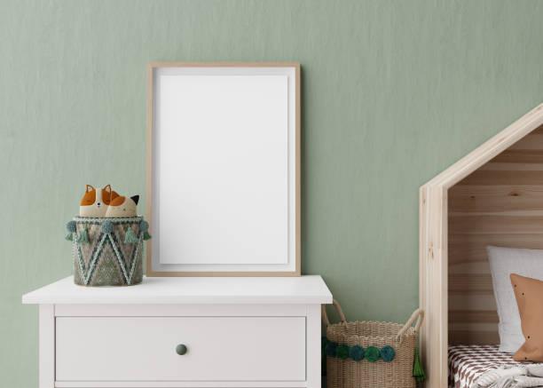 istock Empty vertical picture frame on green wall in modern child room. Mock up interior in scandinavian style. Free, copy space for your picture. Console, rattan basket. Cozy room for kids. 3D rendering. 1389314457