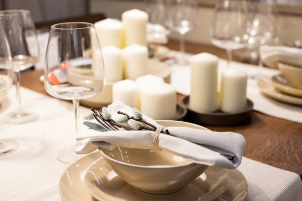 istock Festive Easter table setting with beige plates and floral decor on Stylish table background.happy Easter holiday table with pussy willow branches 1389314482