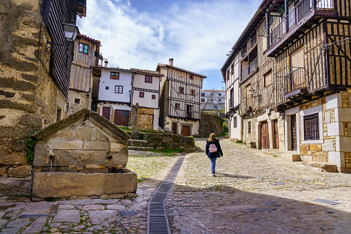 Woman walking through the medieval streets of the mountain village of La Alberca, Salamanca