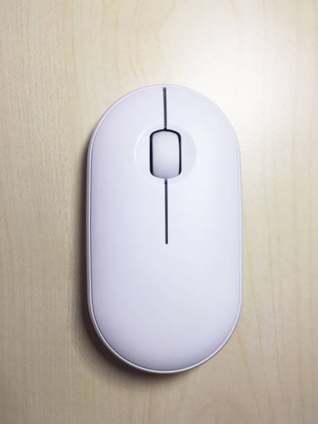 istock Computer mouse on the wooden desk 1389319512