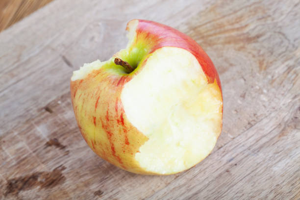 istock red ripe apple on a wooden chopping board 1389319677
