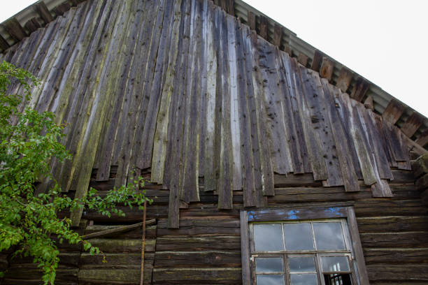 istock an old wooden abandoned house with boarded-up windows 1389319734