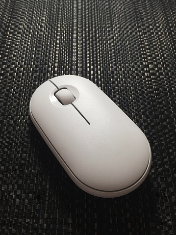 Computer mouse on the wicker textured mouse pad