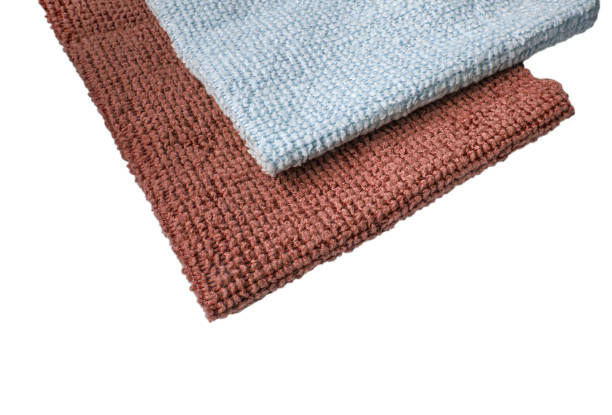 istock Brown and blue microfiber fabric, highlighted on a white background. New soft microfiber material for cleaning objects and surfaces. Isolated on a white background by clipping 1389321813