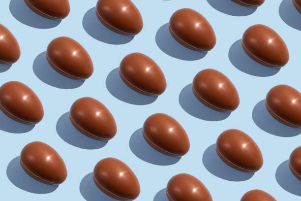 istock Chocolate eggs. Easter eggs. Seamless pattern of whole chocolate eggs on a blue background. Easter chocolate background 1389322695