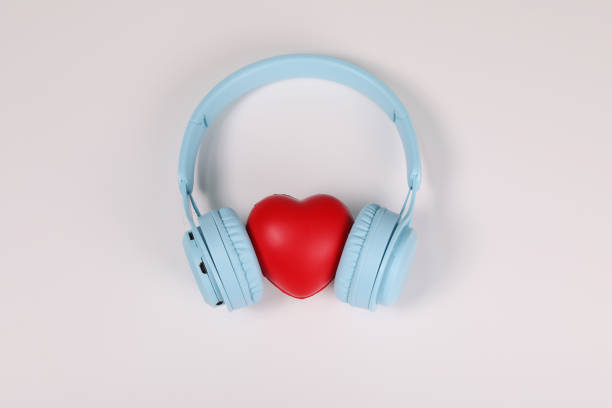 istock light blue headphones with red heart sign in the middle on white surface. 1389322739