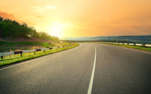 istock Asphalt highway against sunset yellow sky 1389323176