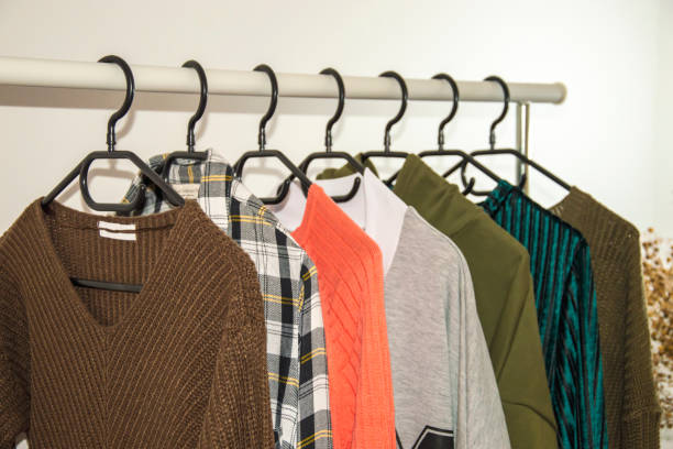 istock White Rack clothes hanger, black plastic hangers. 1389324193