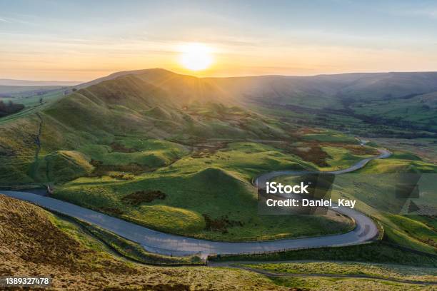 Sunset At Mam Tor In The Peak District With Long Winding Road Leading Through Valley Stock Photo - Download Image Now