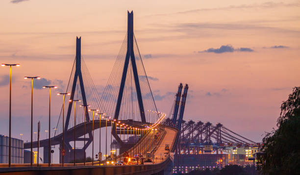 köhlbrandbrücke im hamburger hafen am abend - köhlbrandbrücke stock-fotos und bilder