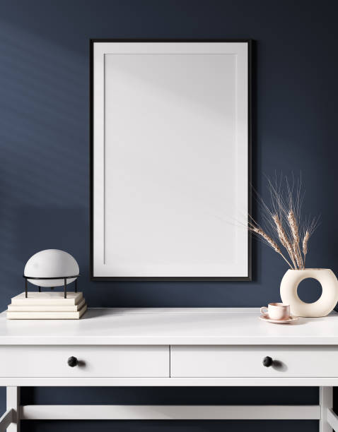 istock Interior poster mockup with vertical black frame on the table with wheat in vase and lamp on empty blue wall background. 3D rendering 1389328756