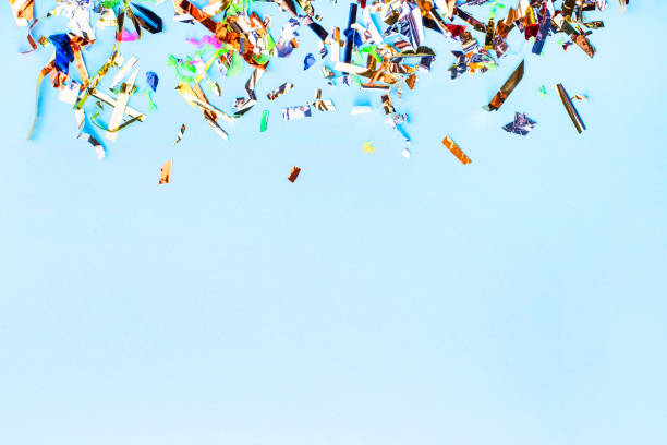 istock Shiny sparkling confetti on a light blue background. Festive background. Perfect backdrop for a presentation. Abstract holiday concept. Copy space. Flat lay 1389329876