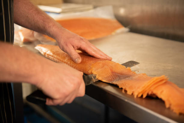 istock Smoked salmon being prepared by Smokehouse worker 1389329932
