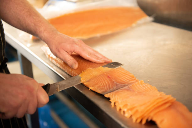 istock Smoked salmon being prepared by Smokehouse worker 1389329978