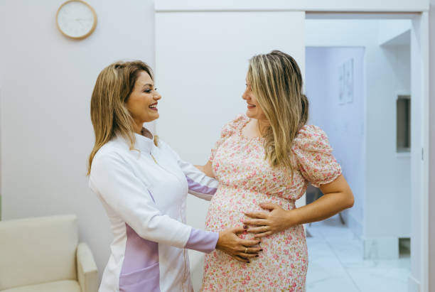 Portrait of pregnant woman and obstetrician nurse Portrait of pregnant woman and obstetrician nurse Midwife stock pictures, royalty-free photos & images