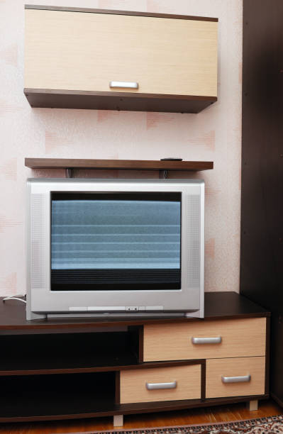 istock Old TV with noise and interference on the screen in the interior. 1389332186