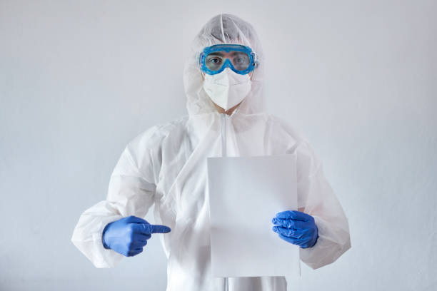 istock Doctor Holding Blank Paper Against White Background 1389333510