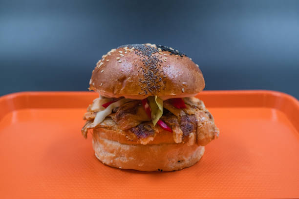 istock Traditional Turkish Doner Kebab between burger bread on orange tray 1389334672