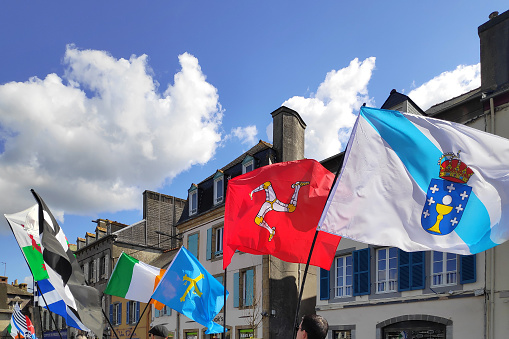 Landerneau, France - April 03 2022: Flags of the Celtic nations from a celtic themed float of the Carnaval de la Lune Etoilée.