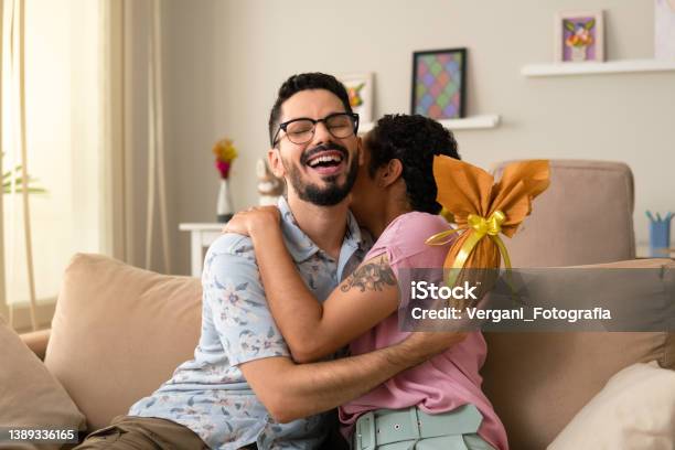 Man Hugging Woman With Golden Easter Egg Stock Photo - Download Image Now - Easter, Easter Egg, Chocolate