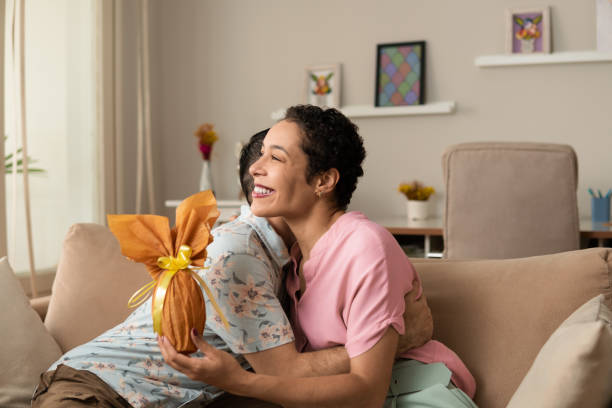 istock Woman hugging boyfriend with golden easter egg 1389336166