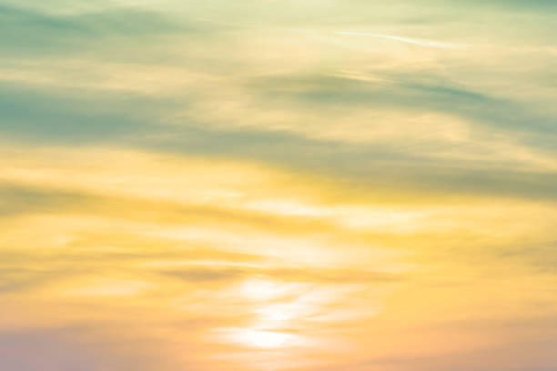 Photo of sunset background. sky with soft and blur pastel colored clouds.  gradient cloud on the beach resort. nature. sunrise.  peaceful morning. Instagram toned style