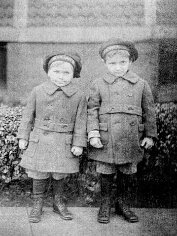 Photograph of two young boys in coats