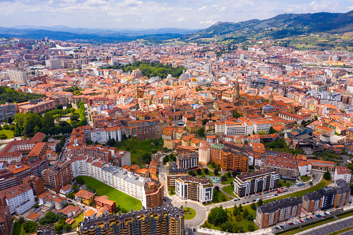 View from drone of residential areas of Spanish city of Oviedo on background on summer mountain landscape