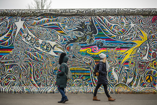 February 27, 2022 - Berlin, Germany:  Fragment of East Side Gallery in Berlin, Germany. It's a 1.3 km long part of original Berlin Wall which collapsed in 1989, and now is the largest world amateur art gallery of graffiti