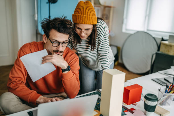 istock Businesswoman discussing with male worker in studio 1389344804