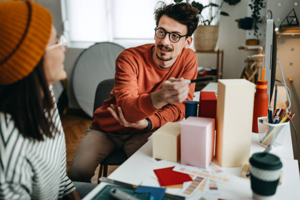 istock Colleagues discussing new products in creative office 1389344868