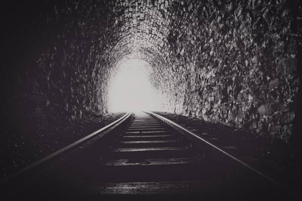 istock dark tunnel with a bright light at the end 1389344965