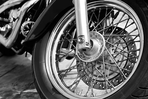 Front wheel of retro motorcycle. Black and white vintage style.