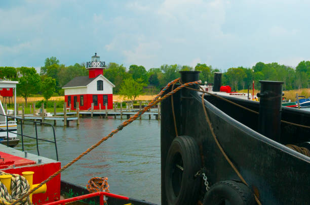 istock Lighthouse-Tug boat with lighthouse in background-Douglas  Michigan 1389348182