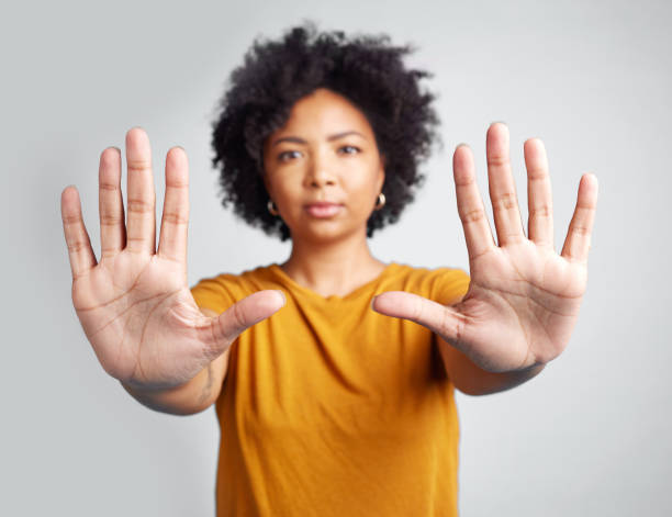 istock Studio shot of a woman gesturing to stop while standing against a grey background 1389349387