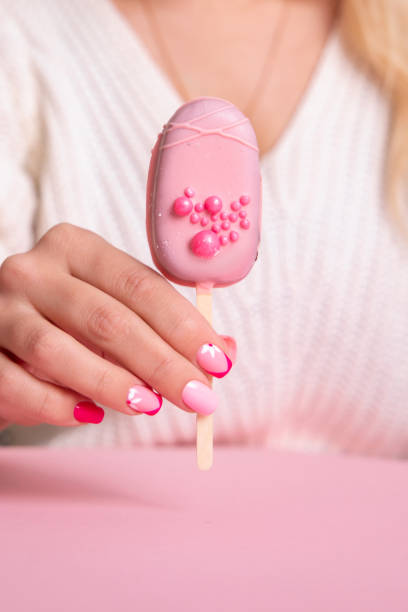 istock Female hand with pink manicure nails 1389351078