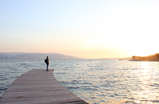Kocaeli, Turkey - April 11, 2015: A sad young man watching the sunset on marmara sea in sekapark kocaeli, Turkey.