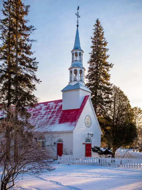 St. Bernard chapel at Mont-Tremblant ski resort, Quebec, Canada at the end of a sunny winter day with snow on the ground
