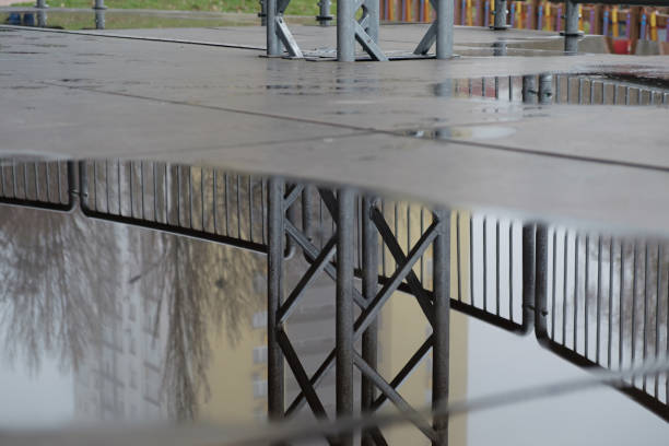 istock Reflections of structures in the puddles 1389352270