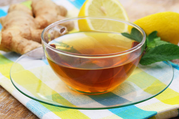 istock Tea in transparent cup with lemon, mint and ginger in the background 1389353187