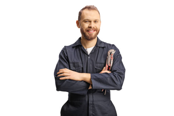 istock Plumber in a uniform holding pliers and looking at camera 1389355702