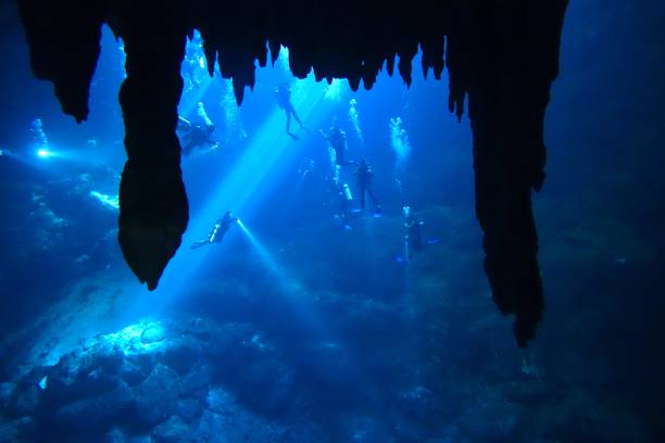 istock Diving in The Pit cenote, Tulum, Mexico 1389359001