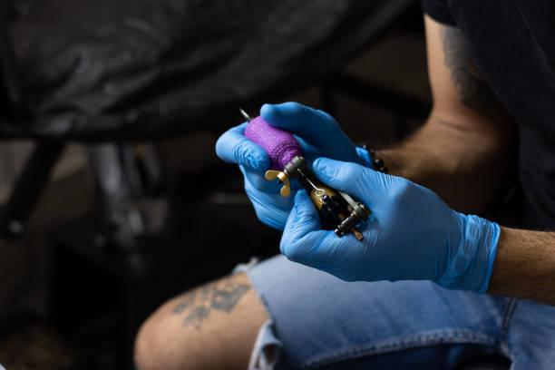 istock Unrecognizable person artist preparing tattoo machine before making a tattoo 1389360119
