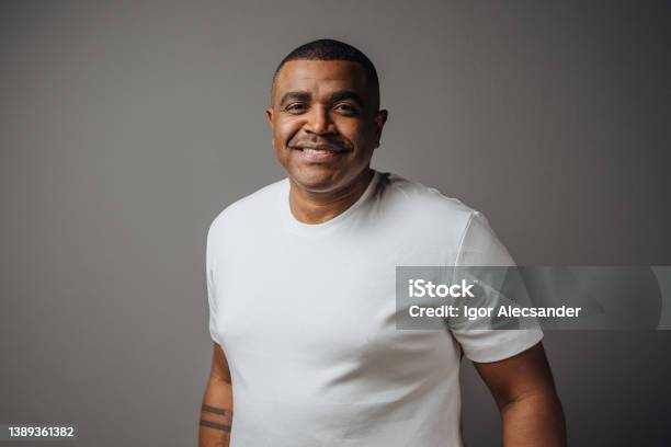 Portrait Of A Man Wearing White Tshirt In Studio Stock Photo - Download Image Now - African-American Ethnicity, Black People, African Ethnicity